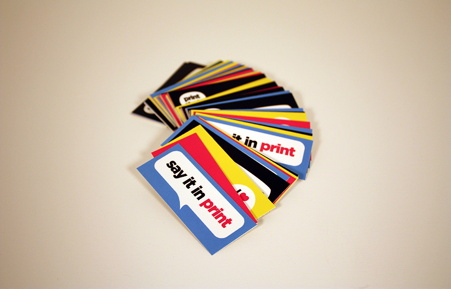 image of a stack of business cards that have been spread out and are printed in many colors