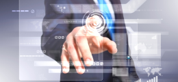 man in a suit pressing one finger on a digital display